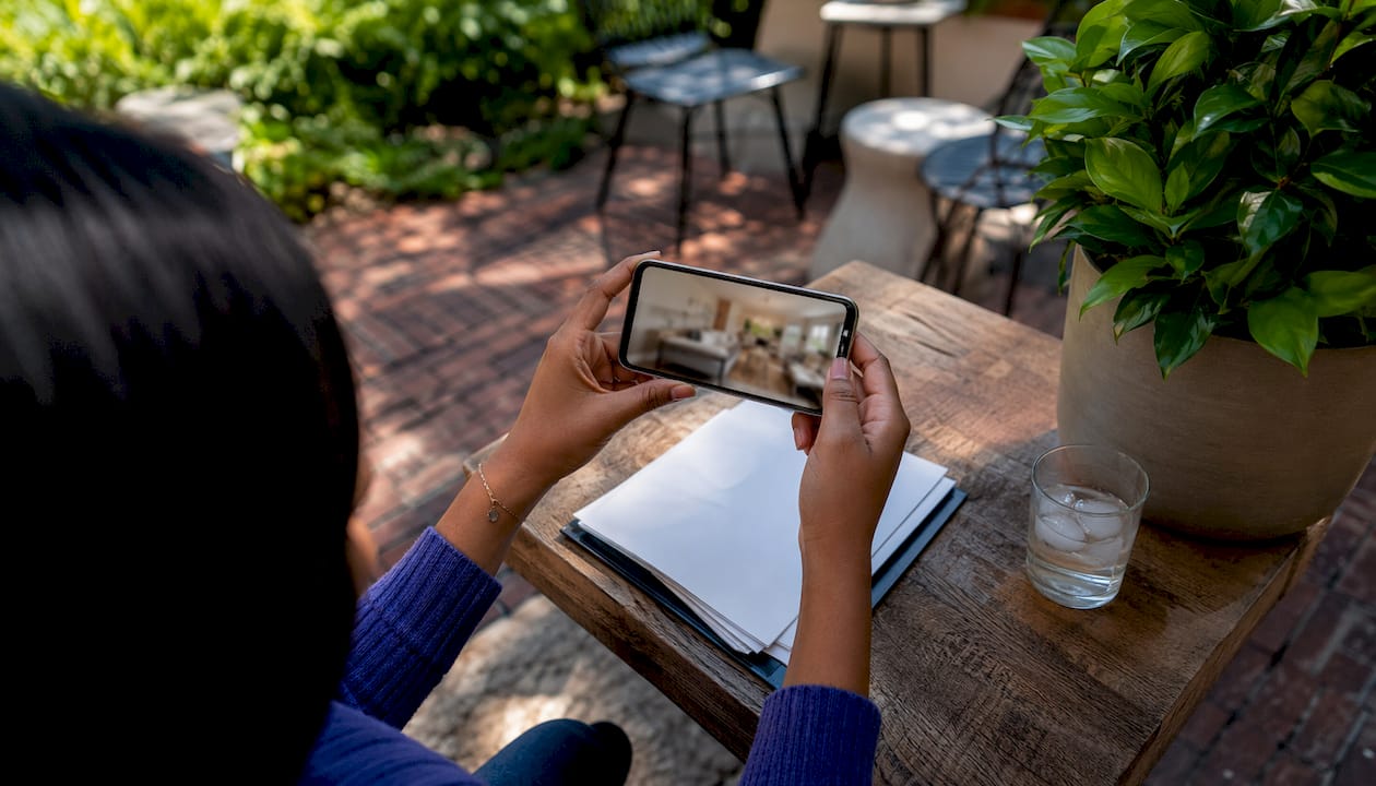 Hands holding phone with rental inspection photos